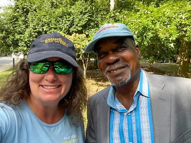 A man and a woman smile for a selfie.