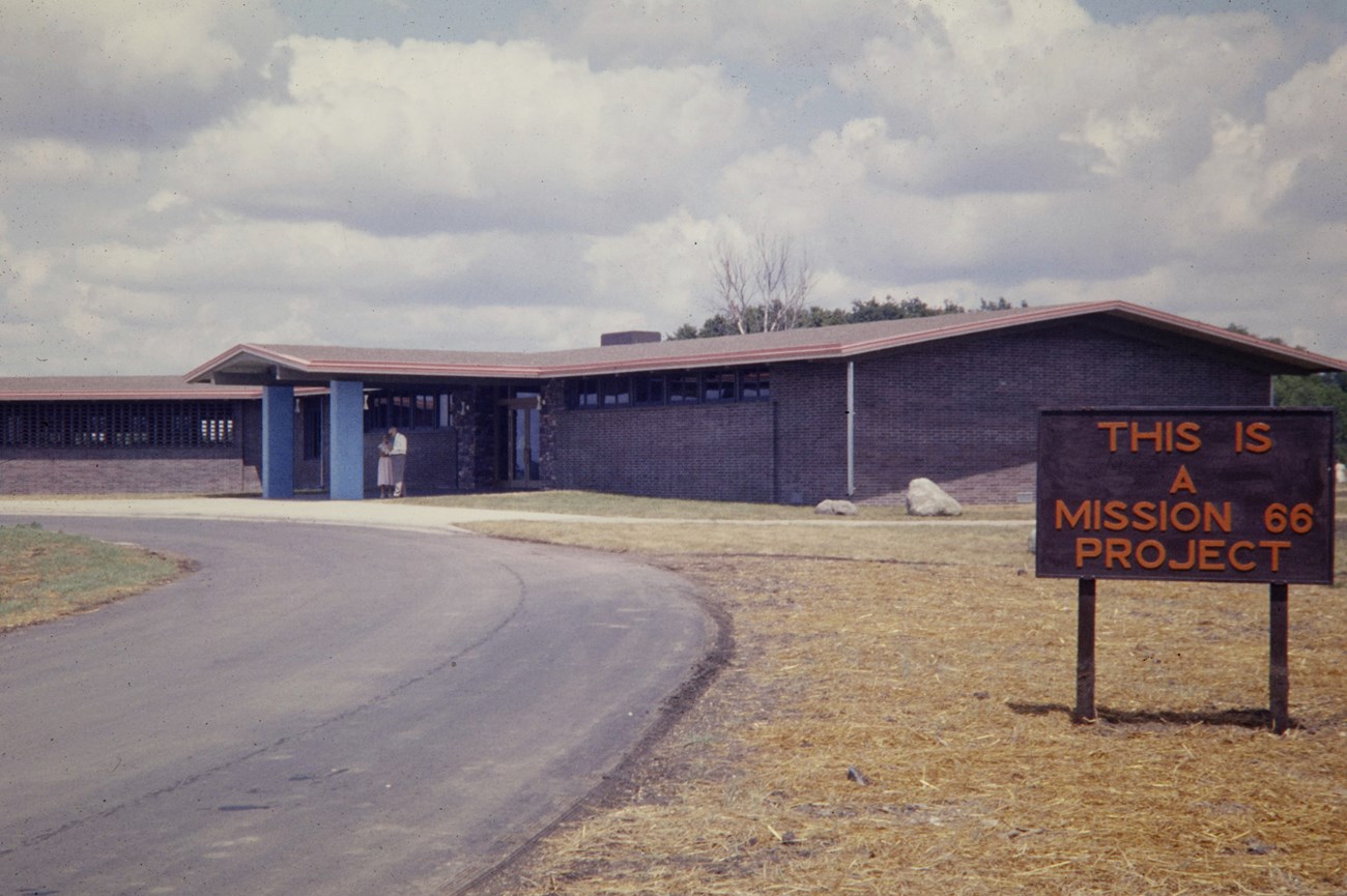 Pipestone Mission 66 Visitor Center (Edited) - NPS Historic Photo Collection Building with a sign that says "Mission 66"