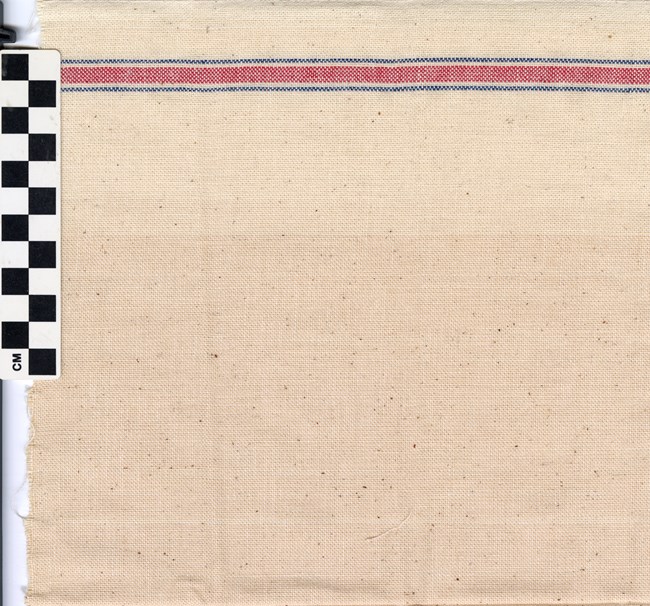 Plain Weave Sample_WR Image of woven cloth with a thin blue stripe, thick red stripe, and another thin blue stripe at the top. In the top left corner is a black and white checkered rectangle