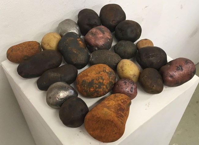 Many cast iron potatoes of different styles and colors