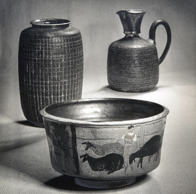 Three clay pots of various sizes, shapes, textures and designs