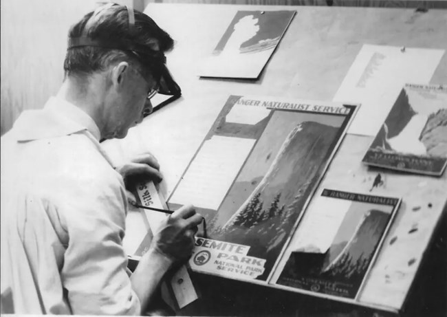 C. Don Powell at a drafting board working on posters