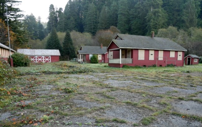 Non-contributing pavement at Prairie Creek Fish Hatchery, Redwood National Park, California Wooden fish hatchery buildings in the background and paved surface in the foreground.