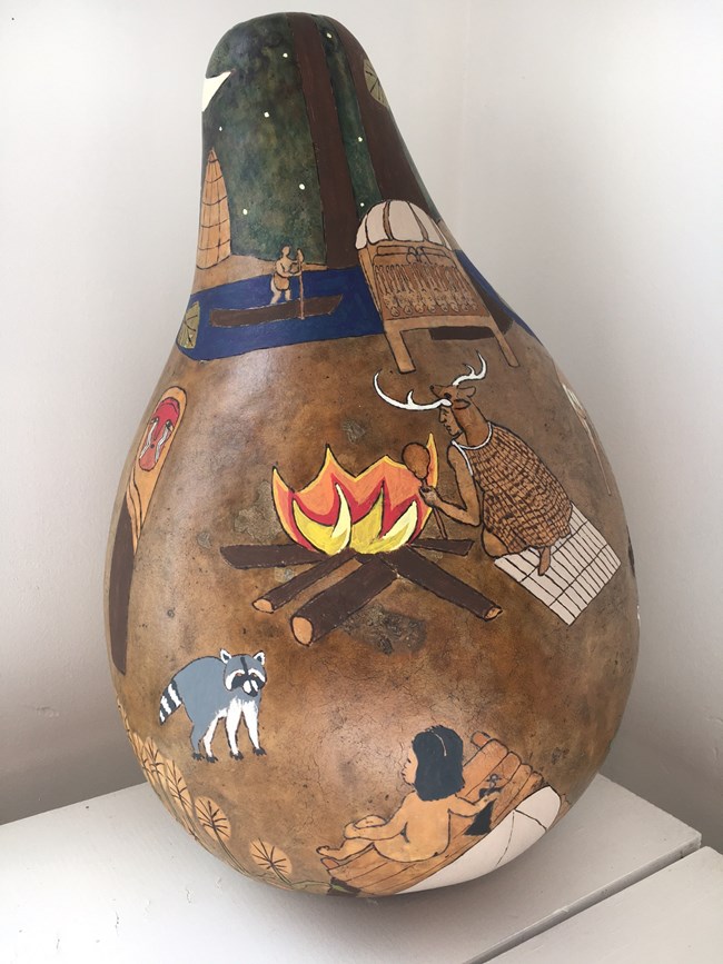 Gourd art showing a man wearing the clothing of a 1600s Virginia Indian priest