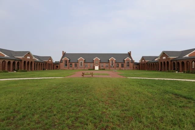Lorton_Reformatory_2020a2 A gratssy courtyard within an imposing brick building.