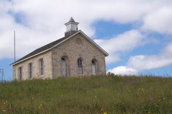 Looking up at limestone schoolhouse on hill