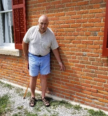 RR FS A former student of the brick school points to the brick in which he carved his initials.