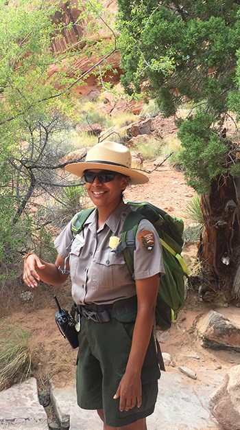 Ranger Edmonia and bug Park Ranger smiling with bug on her hand