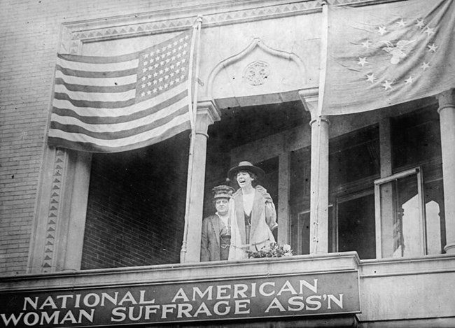black and white photo of new women on a balcony. LOC