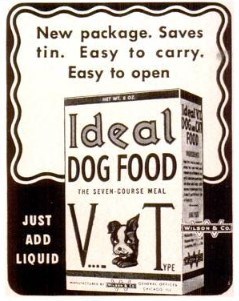 A black and white advertisement showing a box of “Ideal Dog Food: The Seven-Course Meal. Victory Type” with the face of a cute dog on it. Around the box it reads, “New package. Saves tin. Easy to carry. Easy to open. Just add liquid.”