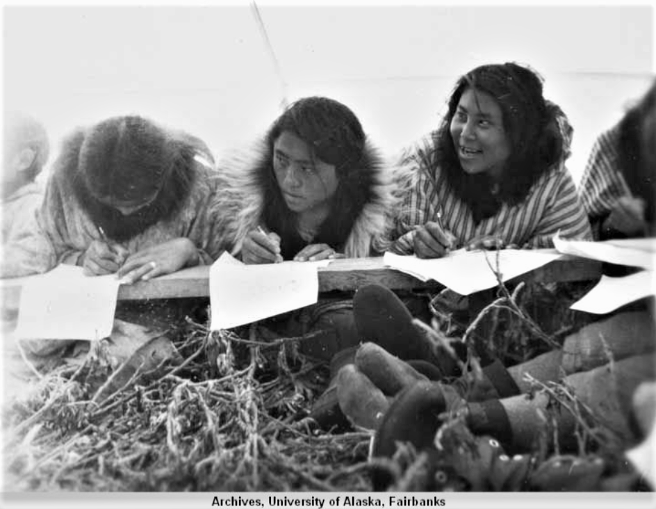 Black-and-white photograph of young Nunamiut women at school in a wall tent Black-and-white photograph of young Nunamiut women at school in a wall tent