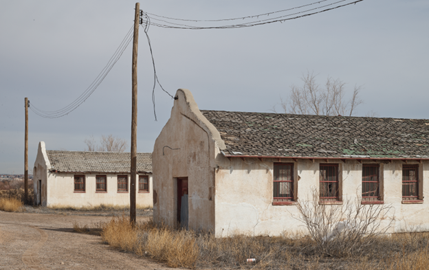 Rio Vista Farm Socorro Two deteriorated adobe brick buildings.