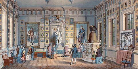 A room with high ceilings lined with portraits on the wall and visitors miling around