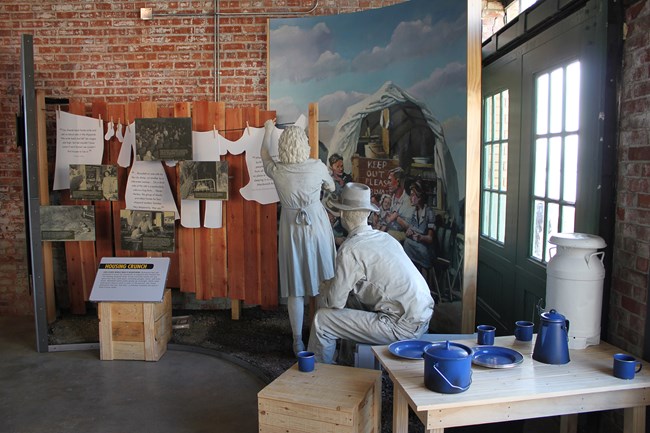 Life Cast exhibit with man and woman hanging laundry.