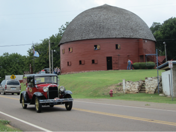 lt= A large round building with a thatched roof.