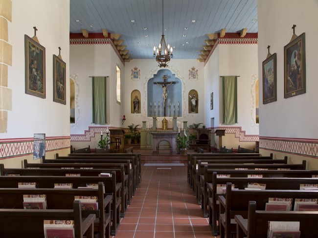 Royal Presidio Chapel Interior Rows of dark pews facing the main chapel altar