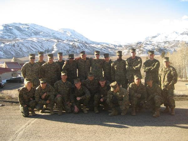 Steve Sabol and fellow marines; MWTC Bridgeport, CA, 2007. Sabol is in the top row, 3rd from right. A group of marines pose for a photo with snow covered mountains in the background.