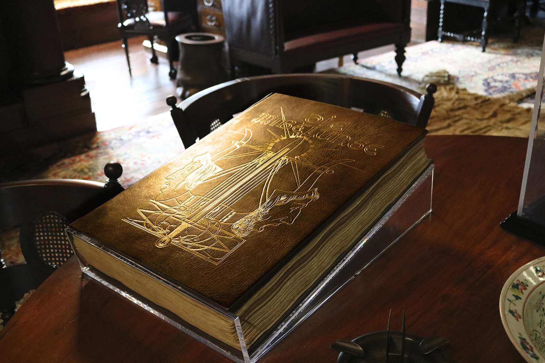 Nibelungenlied Brown historic book with gold imagery on the cover displayed on a table.