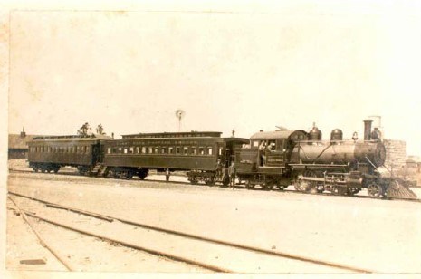 a train engine pulling two cars on a track