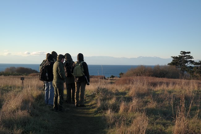 Pacific West Regional FMSS & Cultural Landscapes team with San Juan Island National Historical Park staff hiking through American Camp Cultural Landscape, December 2013.