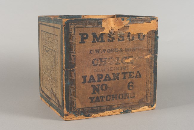 Tea chest label Wooden tea box with faded black lettered paper label.