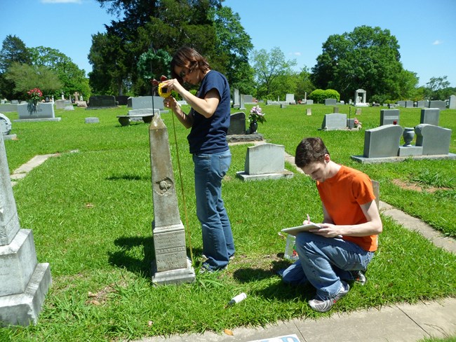 Students document monuments and grave markers in a cemetery. Students document monuments and grave markers in a cemetery.