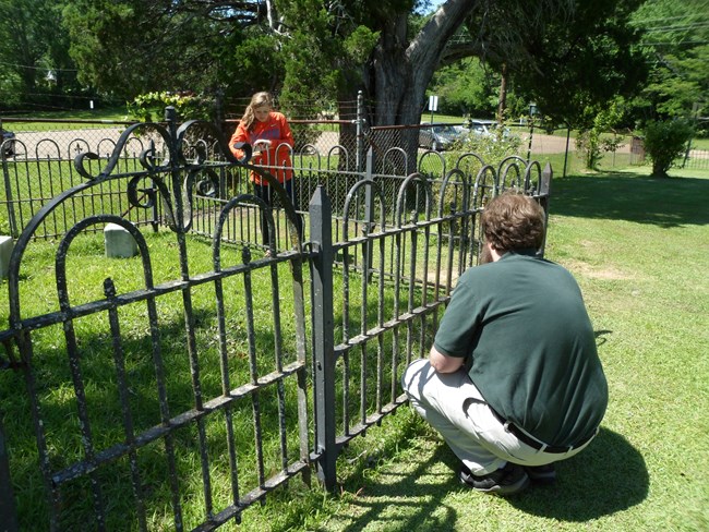 Iron fence repair in a cemetery. Iron fence repair in a cemetery.