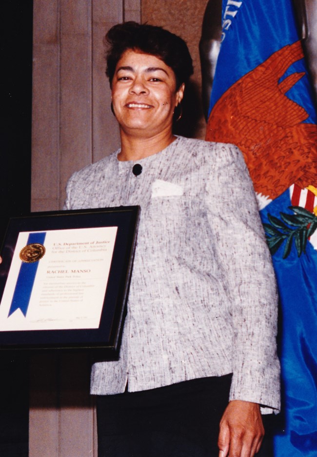 Raquel Manso award Raquel Manso in civilian clothes poses with an award certificate.