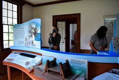 Two people in an exhibit room.