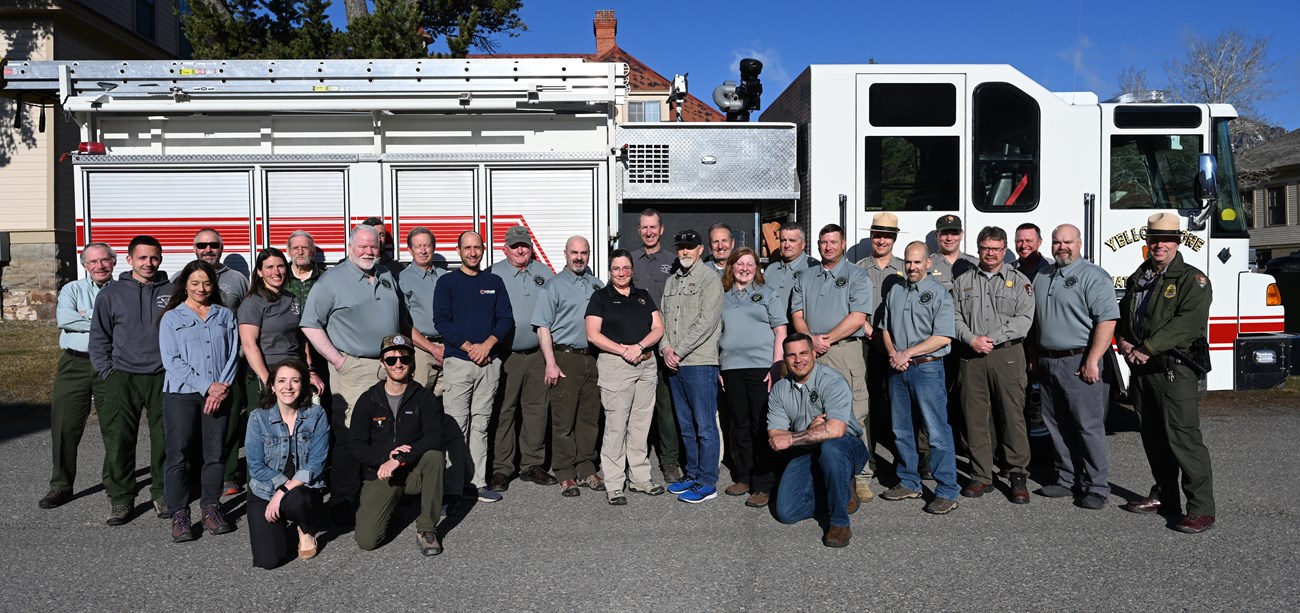 Structural Fire Leadership Council A group of people pose in front of a structural fire engine.