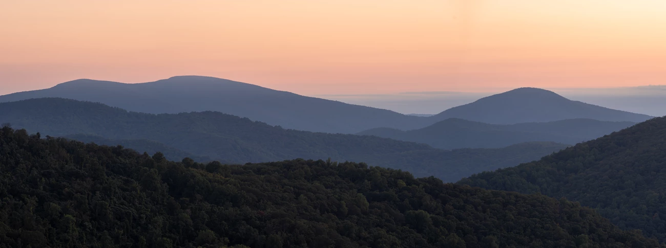 A pink sunrise over mountains. A pink sunrise over mountains.