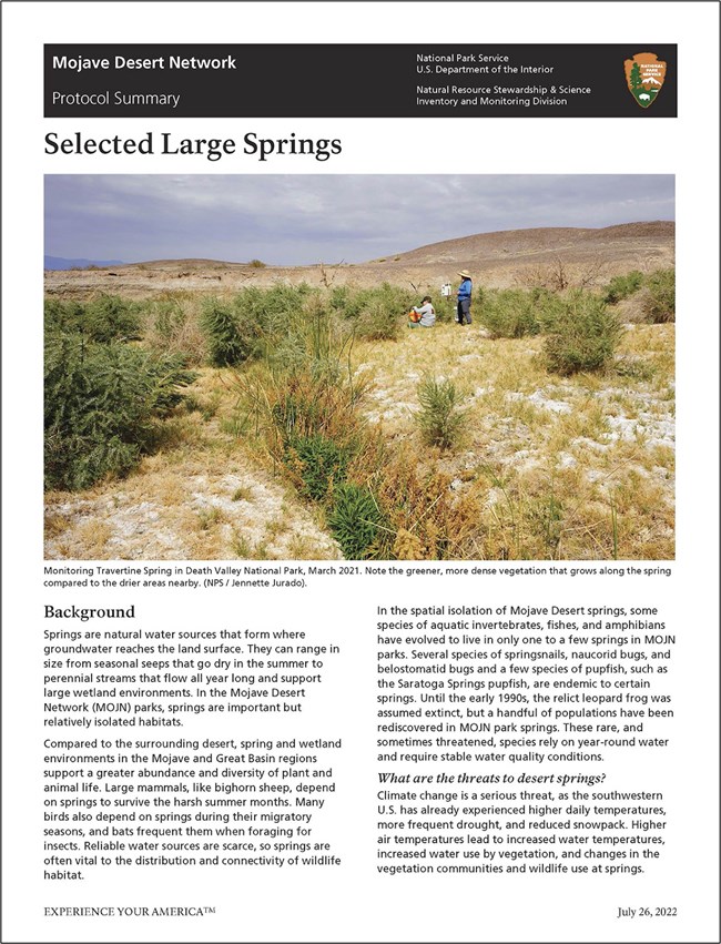 Image of first page of monitoring brief showing a large photo of two scientists standing near a desert spring surrounded by green vegetation.