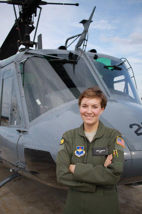 Sabina Shaub stands in front of a helicopter