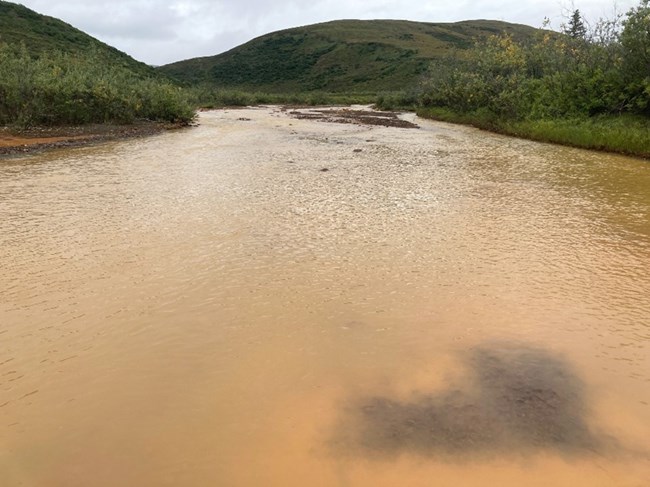 a river with water that appears orange from rust