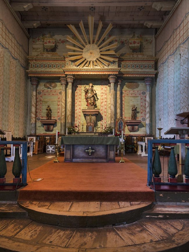 Closer view of the brightly painted altar in the Mission San Miguel Arcángel