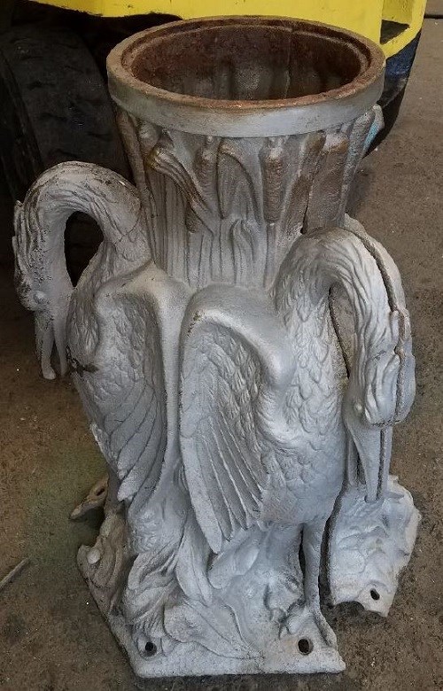 The fountain pedestal with standing bird motif. The basin has been detached and metal is exposed after sandblasting.