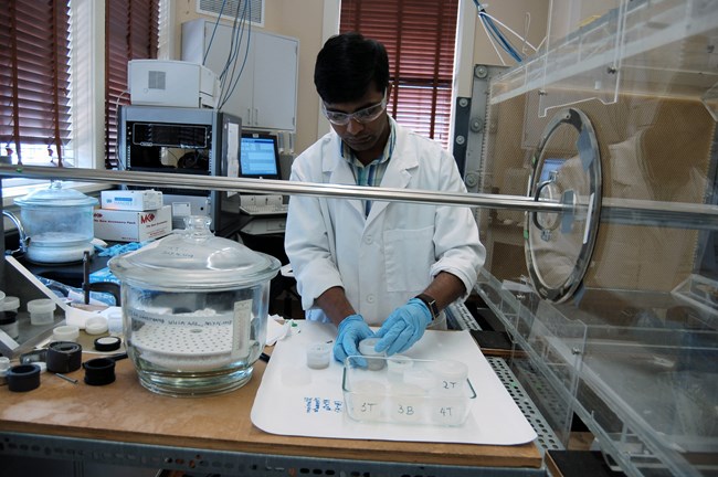 Satish Pandey loading samples in NCPTT’s recirculating wind tunnel. Satish Pandey loading samples in NCPTT’s recirculating wind tunnel.