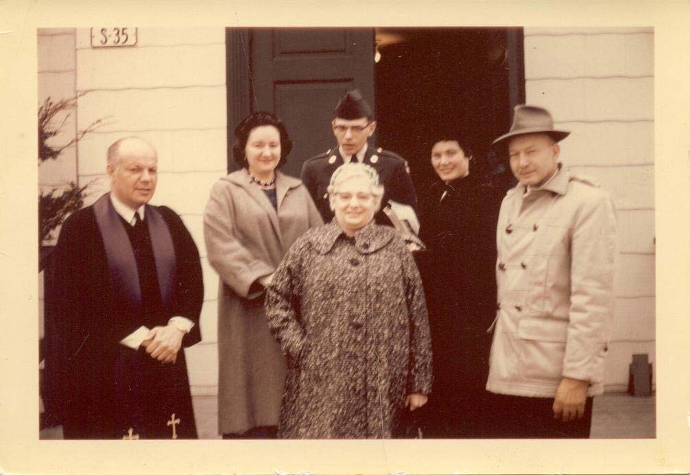 a family stands on church steps