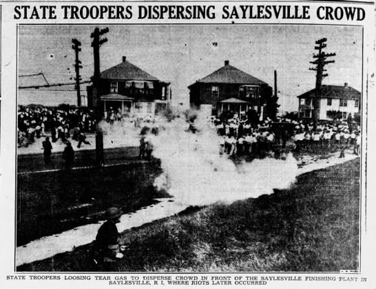 Saylesville Strike Tear Gas Large crowd of people disperse as cloud of white smoke rises in the center of the photo
