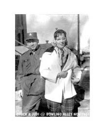 a woman stands next to a man in a military uniform