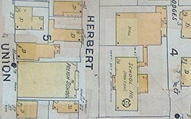 Gray map with yellow buildings showing buildings on either side of Herbert Street.