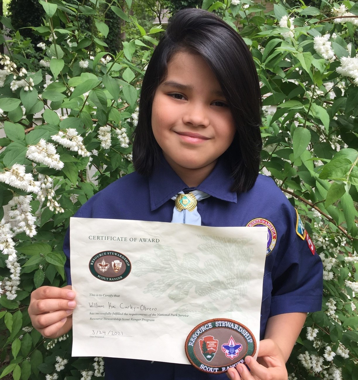 William Kai holding his Resource Stewardship Scout Ranger Certificate Award