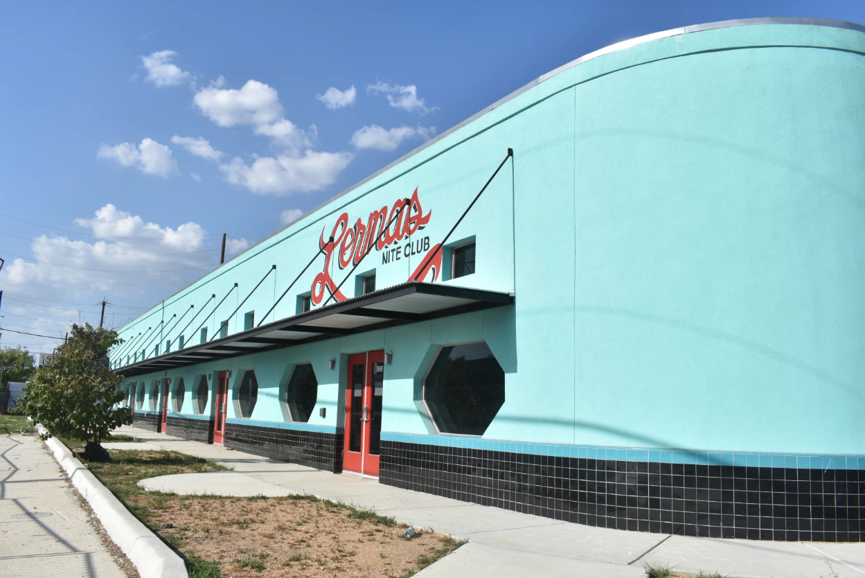 Lerma's Nite Club Side profile of blue building with red accent marks and a black and white tile border along the bottom of building