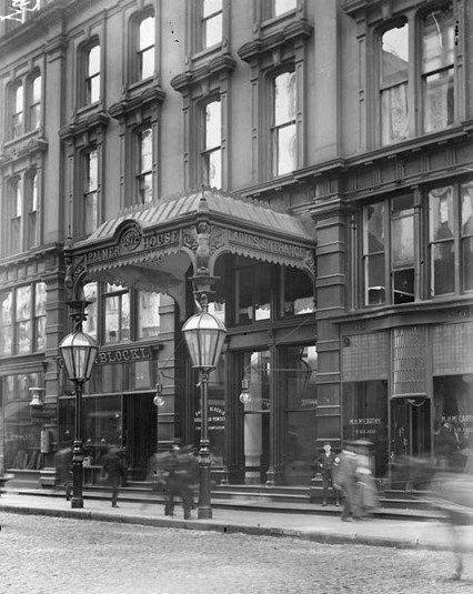 Exterior of a building; portico over the entrance reads Palmer House Ladies Entrance