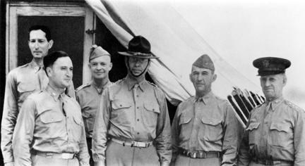 A black and white image of several officers standing in uniform