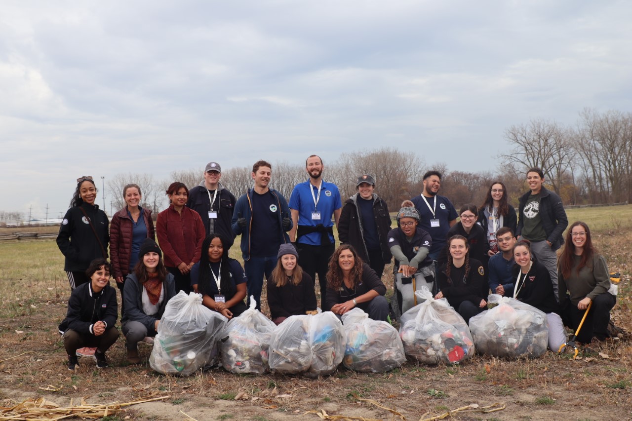 September 2022 Cohort-CVA NEST - 3 A group of Community Volunteer Ambassadors and Conservation Legacy staff pose with full garbage bags from a volunteer service project.