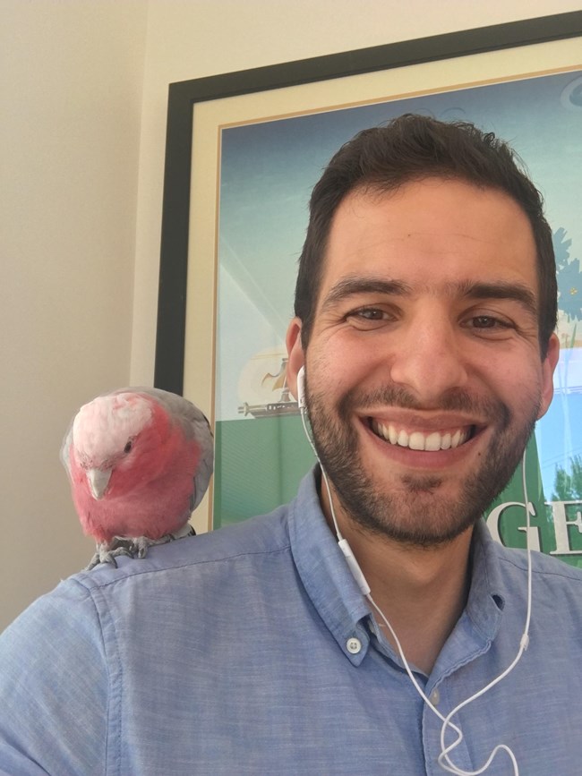 Man with parrot on his shoulder.
