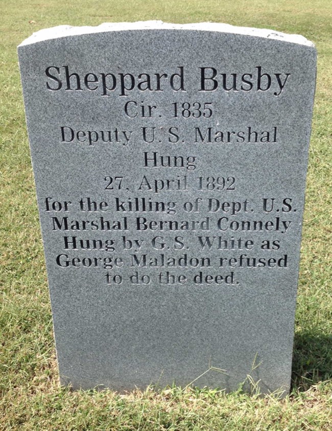 Sheppard Busby Tombstone at Oak Cemetery A tombstone with text reading Sheppard Busby Cir. 1835, Deputy US Marshal, Hung 27, April 1893 for the killing of Dept. US Marshal Bernard Connely Hung by GS White as George Maledon refused to do the deed.