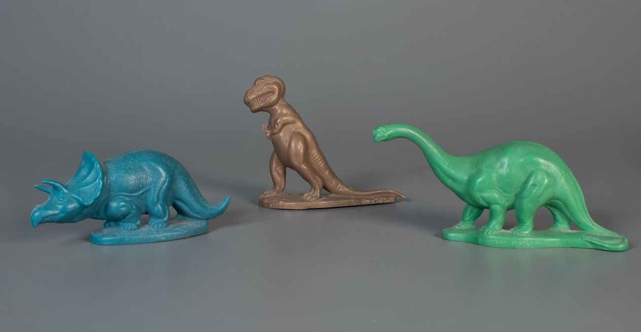 Sinclair Dinosaurs Strong National Museum Three toy dinosaurs on display