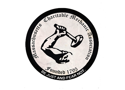 Logo of the Massachusetts Charitable Mechanic Association that has an arm holding up a hammer.